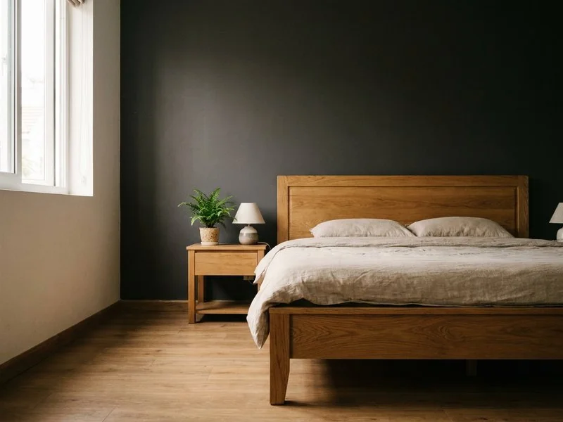 Giường gỗ đầu tựa mảng tường màu trầm cách xa cửa ra vào